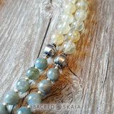 Closeup detail; Crystals for abundance included in the Magical Abundance Mala by Sacred Skaia are citrine, labradorite, pyrite and sandalwood.