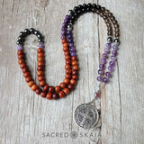 Addiction Recovery Mala by Sacred Skaia, shown as a companion to the Addiction Recovery Bracelet in custom sizes for supporting your intention to be free from addiction, made with amethyst, hematite, smoky quartz, black obsidian, lepidolite and rosewood. Includes silver accents.