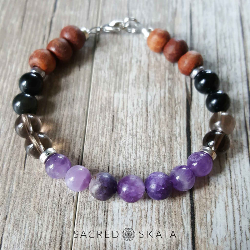 Crystal beaded bracelet in custom sizes for supporting your intention to be free from addiction, made with amethyst, hematite, smoky quartz, black obsidian, lepidolite and rosewood. Includes a silver lobster clasp and silver spacers.