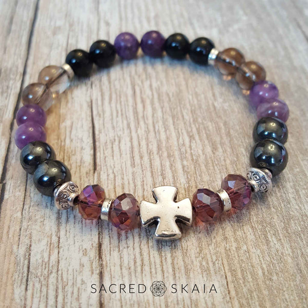 Crystal stretch bracelet in custom sizes for supporting your intention to be free from addiction, made with amethyst, hematite, smoky quartz, black obsidian, lepidolite and rosewood. Includes a silver cross accent and silver spacers.