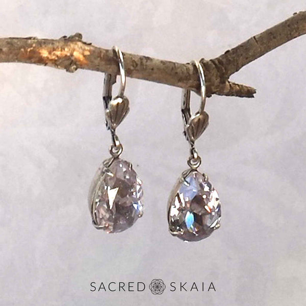 Vintage-style Aphrodite Crystal Teardrop Earrings with oxidized silver settings, lever back ear wires and pear-shaped smoky mauve (pale lavender gray) Swarovski crystals, shown hanging on a branch