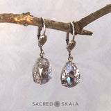 Aphrodite Crystal Teardrop Earrings with oxidized silver settings, lever back ear wires and pear-shaped smoky mauve (pale lavender gray) Swarovski crystals, shown hanging on a branch as an alternate color choice