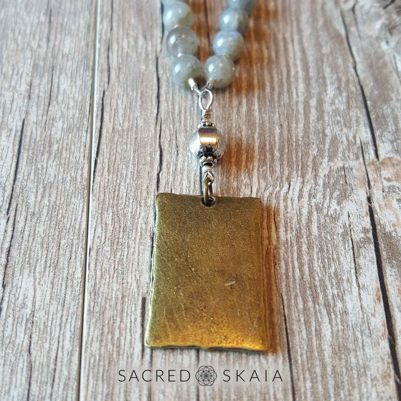 Back of Man in the Moon pendant. Crystals for abundance included in the Magical Abundance Mala by Sacred Skaia are citrine, labradorite, pyrite and sandalwood.